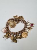 9ct yellow gold charm bracelet hung with 16 charms, examples to include two rolled gold seals and 9c