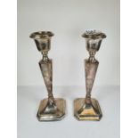 A pair of silver candlesticks by Clark and Sewell, Birmingham 1917. Having tapering columns, AF, 23c