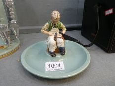 An old Beswick circular tray having central figure of Cobbler for Timpson Fine shoes centenary