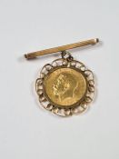 22ct gold half Sovereign dated 1914, George V and George the Dragon in 9ct gold mount suspended 9ct
