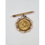 22ct gold half Sovereign dated 1914, George V and George the Dragon in 9ct gold mount suspended 9ct