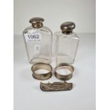 A silver topped glass jar hallmarked London 1876, with another AF. Two silver napkin rings, and a Ma
