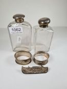 A silver topped glass jar hallmarked London 1876, with another AF. Two silver napkin rings, and a Ma