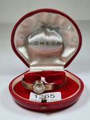 Omega; a vintage 9ct gold cased ladies Omega cocktai watch on 9ct gold strap, champagne face and bat