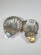 A silver shell trinket dish on three ball feet. Birmingham 1904 with another larger example, Birming