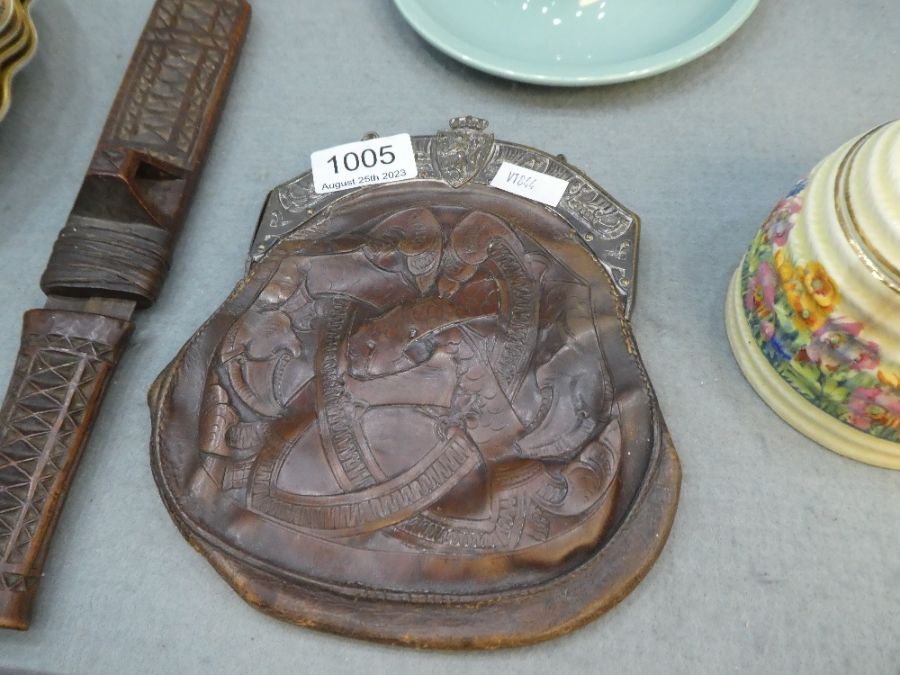 An old leather sporran having silver plated clasp and an African carved dagger with wooden sheaf