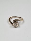 Unmarked white metal solitaire diamond ring with crossover design mounts, round brilliant cut, appro