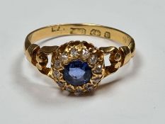 Antique 18ct yellow gold sapphire and diamond cluster ring with central pale blue sapphire surrounde