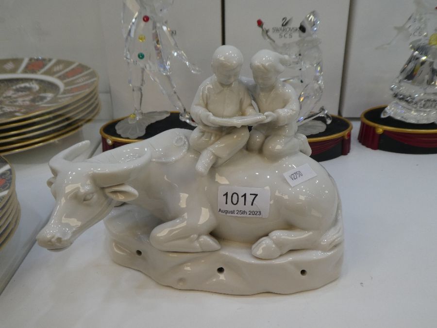 A 20th Century Chinese figure of Water Buffalo with girl and boy on back, white glaze
