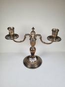 A pair of heavy silver candleabras, not weighted having two branches. On a circular pedestal foot an