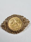 Unmarked yellow gold brooch inset with a 22ct 1908 full Sovereign, Edward VII and George and the Dra