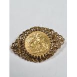 Unmarked yellow gold brooch inset with a 22ct 1908 full Sovereign, Edward VII and George and the Dra