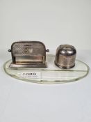 A silver mounted glass combination desk calendar, inkwell. The inkwell having decorative sliding lid