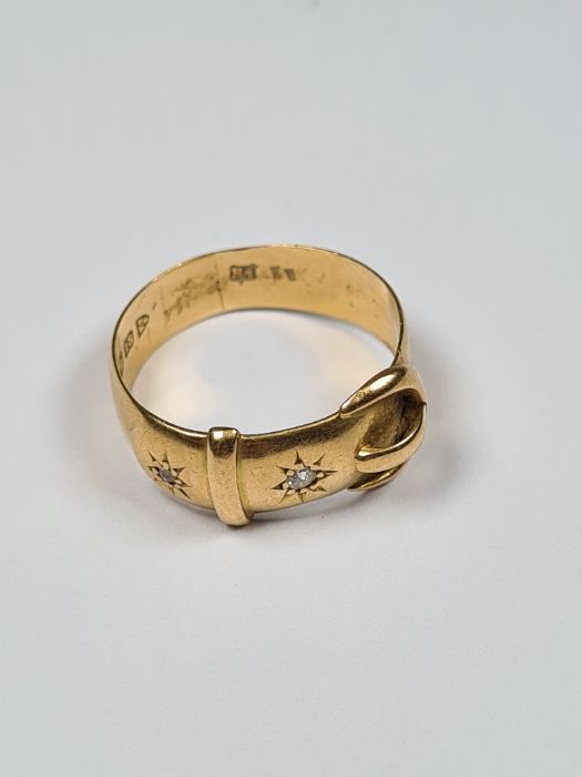 18ct yellow gold buckle ring with two starburst set diamonds, size     , marked 18, Chester maker BS
