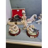 A pair of Lladro fairies having floral encrusted decoration and a Lladro Spanish girl holding flower
