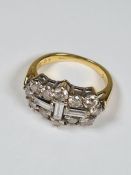18ct yellow gold diamond cluster ring set with three central baguette cut diamonds, surrounded round