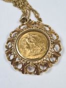 9ct gold chain hung with a 9ct gold pendant mounting a 1974 Full Sovereign, Elizabeth II and George