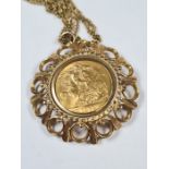 9ct gold chain hung with a 9ct gold pendant mounting a 1974 Full Sovereign, Elizabeth II and George