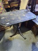 A Victorian black painted tripod table having decoupage decoration on oblong top