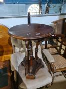 A Victorian mahogany open armchair having button back, a circular table and a sloping deskbox
