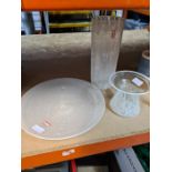 Three white and clear glass items including a circular dish and two vases