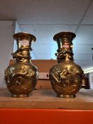 A pair of Chinese brass vases decorated dragons