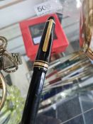 A large black and gilt Mont Blanc roller ball pen and a matching pair containing fountain pen and ro