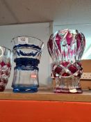 A glass decanter having silver collar and three coloured glass vases