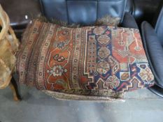 An old Caucasian rug, having repeated central design, a geometric rug and one other