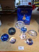Selection of paperweights some marked Medina, and a Bells Whisky decanter with contents
