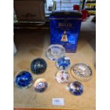 Selection of paperweights some marked Medina, and a Bells Whisky decanter with contents