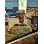 A vintage rocking horse having corduroy upholstery