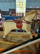 A vintage rocking horse having corduroy upholstery