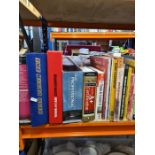 A shelf of books and music tape casettes