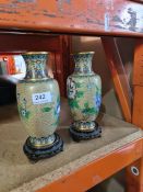 A pair of modern Cloisonné  enamelled vases on wooden stands