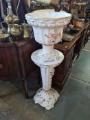 An Italian floral encrusted jardiniere and pedestal stand with maker's mark