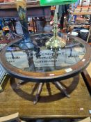A reproduction coffee table in form of a cartwheel with inset glass top