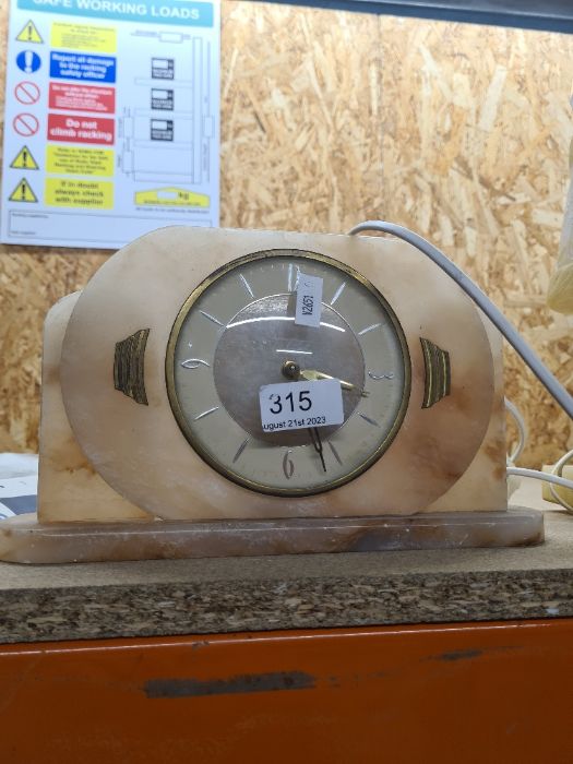 An alabaster electric clock and lamp