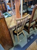 An old stripped pine oblong kitchen table on square legs, 186cms
