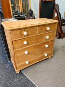 A Victorian pine chest having 2 short and 3 long drawers on turned feet