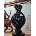 A Victorian black glass vase having painted floral decoration, 42cms