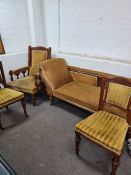 A late Victorian Chaise Longue with carved decoration, a matching open armchair and a pair of bedroo