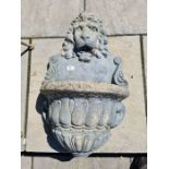 A reconstituted wall fountain decorated lion mask