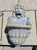 A reconstituted wall fountain decorated lion mask