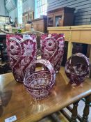 A pair of Bohemian ruby and clear glass vases and two similar glass baskets