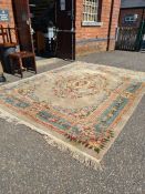 A large modern Chinese carpet having all over floral decoration, with central motif, 368cm x 275cm