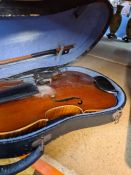 Violin with bow in case. Interior label 'Copy of Antonius Stradivarius'
