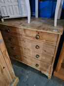 An old stripped pine chest having two short and three long drawers