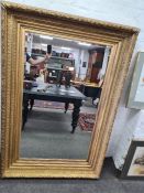 A large Victorian wall mirror having gilt frame with bevelled glass 162.5cm