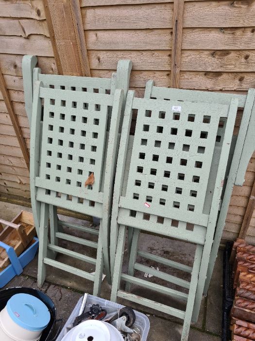 Four folding green painted wooden garden chairs